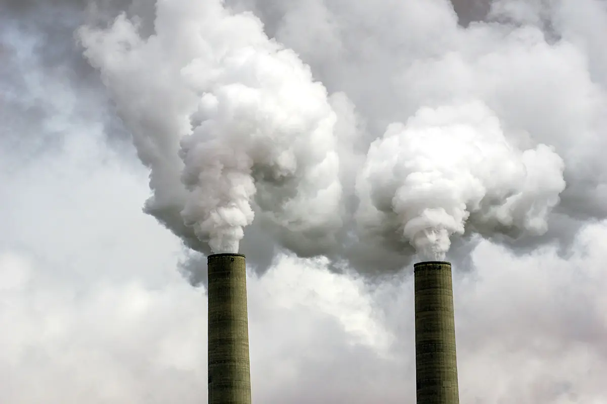Two factory pipes emitting huge amounts of greenhouse gases generated by processing coal.